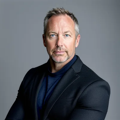 Professional headshot portrait of Dr. Alex Rowan, CTO and Co-Founder of Synthia